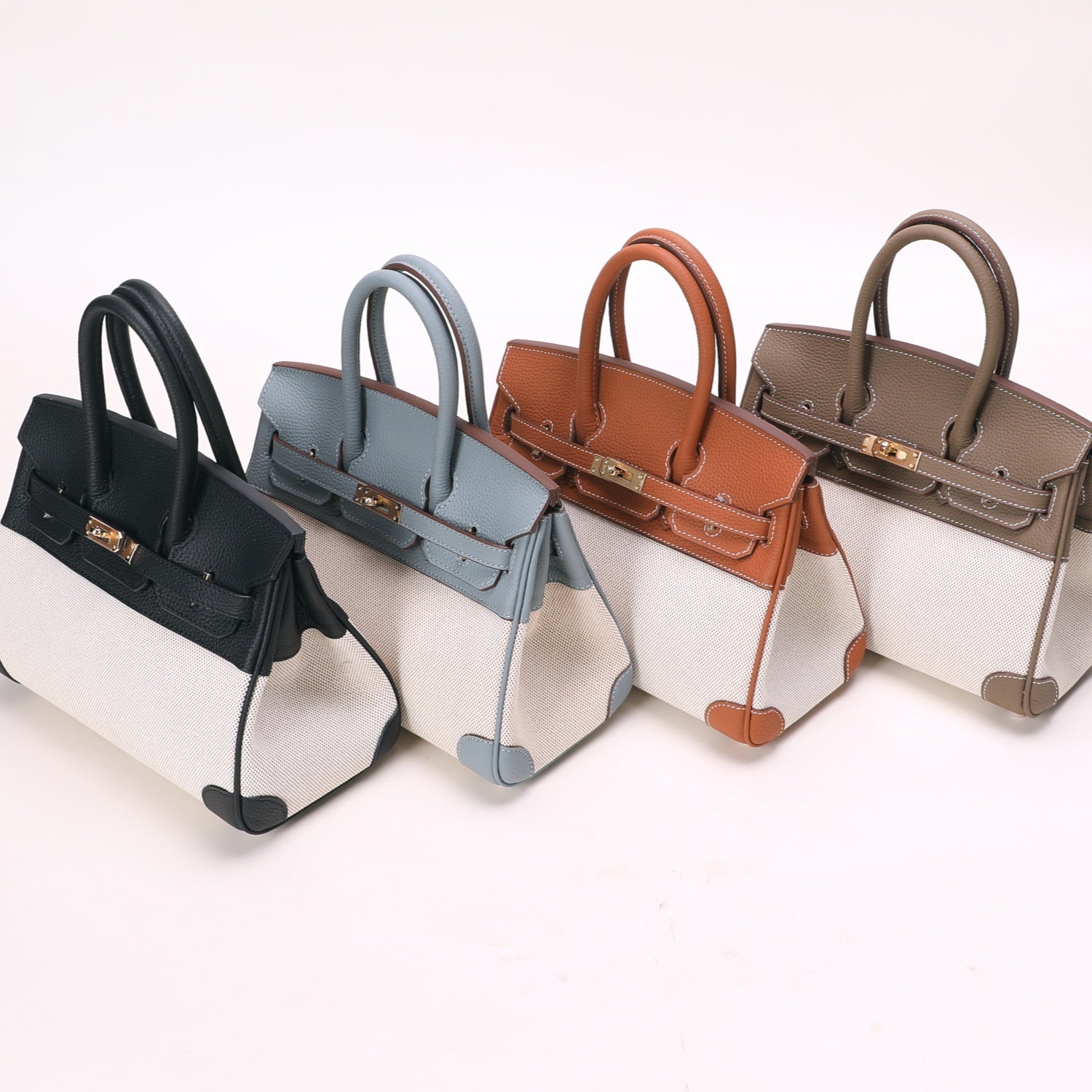 Four stylish handbags in different colors, featuring intricate design details and high-quality craftsmanship.